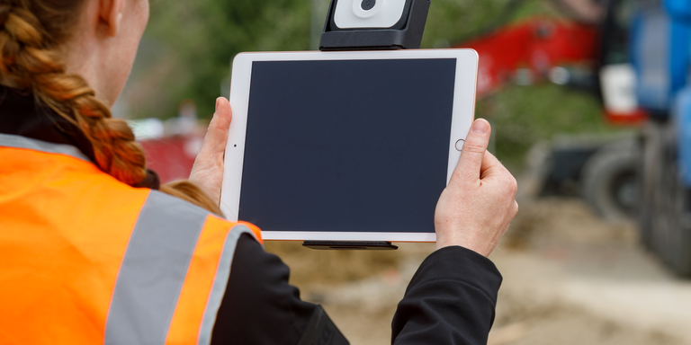 Individual utilizing the Leica FLX100 at a site 