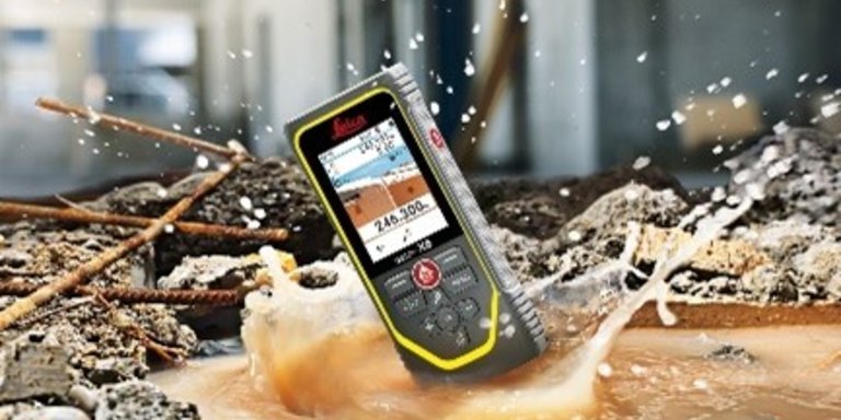 A Leica DISTO X6 laser measure falls into a puddle of water on a construction site 