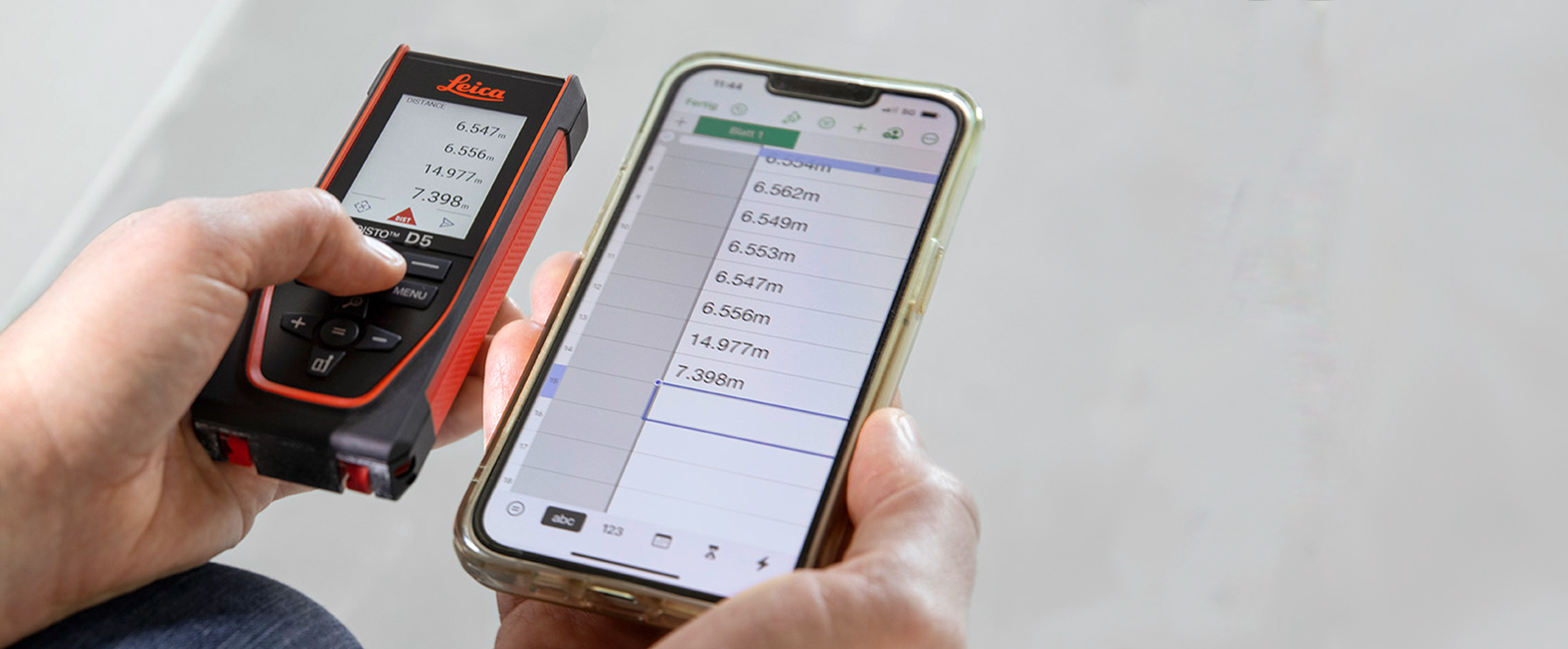 Individual inputting measurements from DISTO D5 into mobile device