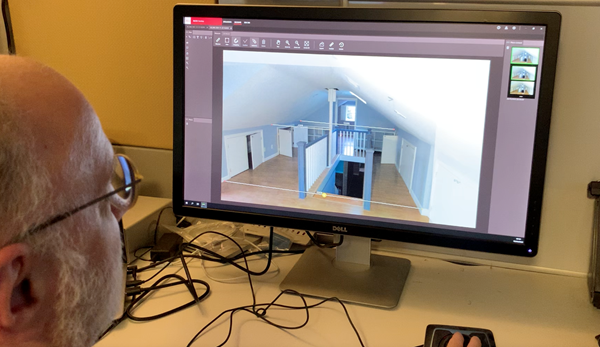 Architect working with a 3D model of a house